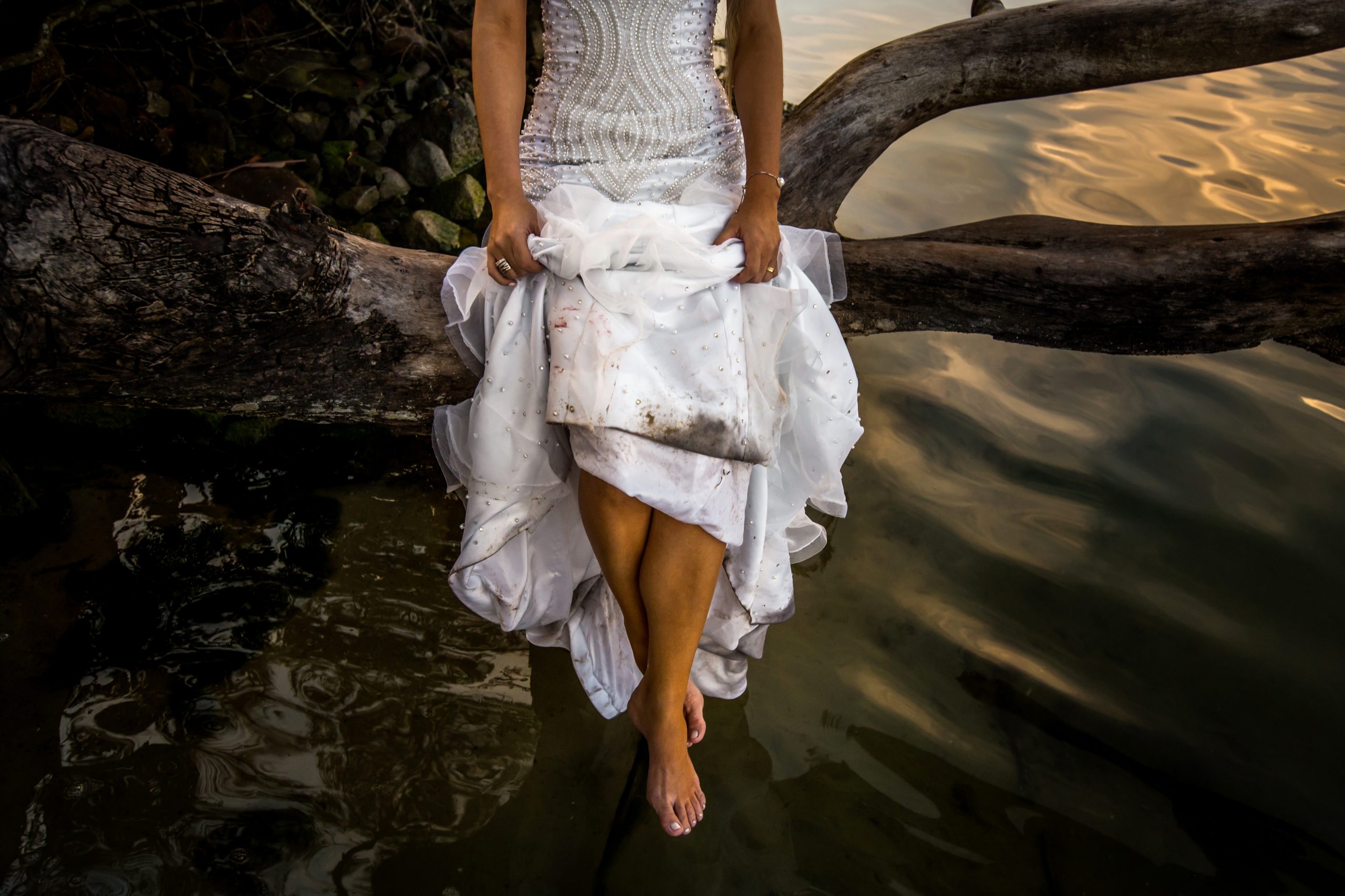 A woman in a dirty wedding dress