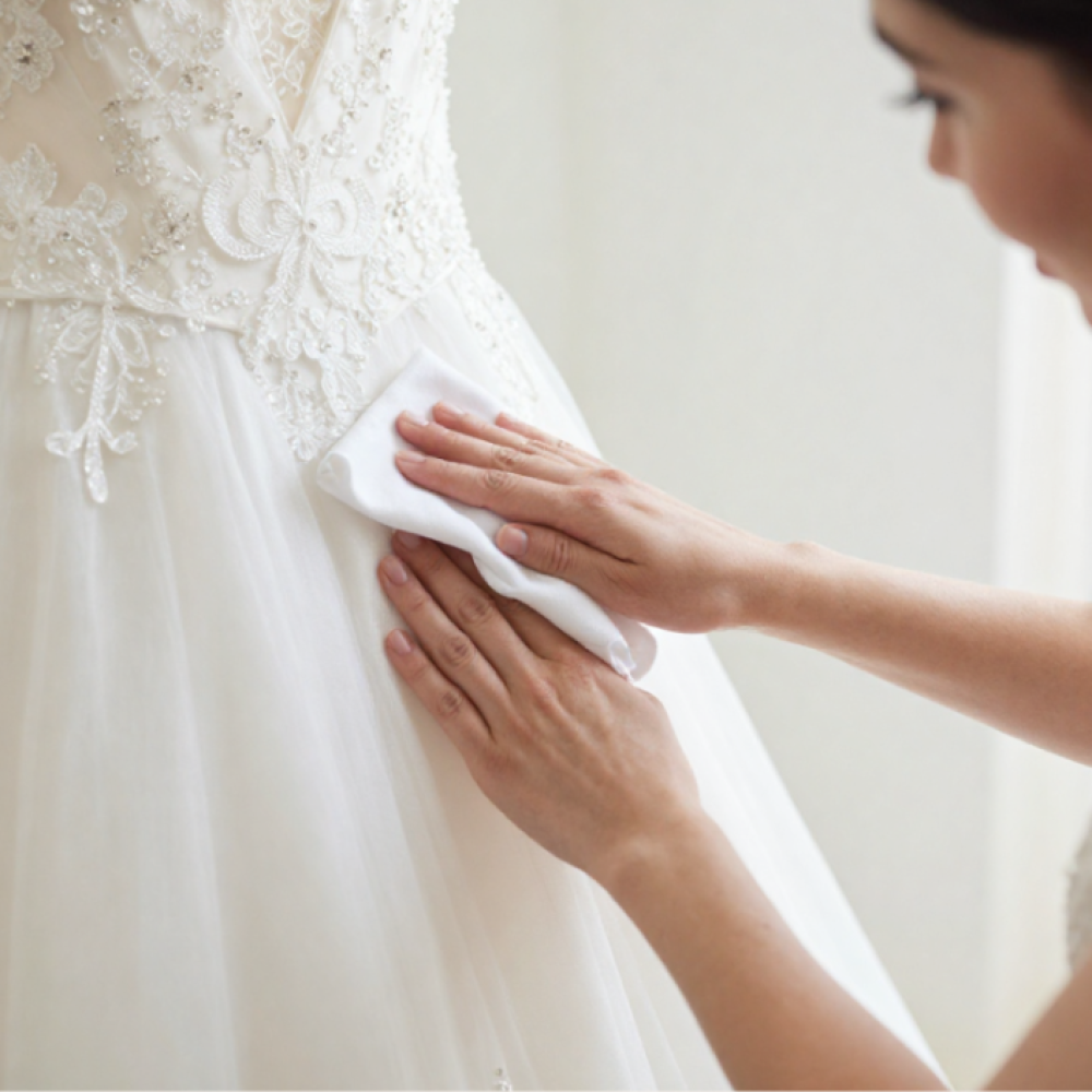 Wedding Dress in Gift Box Presentation (1) A woman cleaning a wedding dress